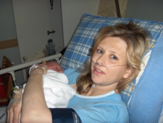 Me with our first baby - I was still coming out of the General Anaesthetic, hence the oxygen through my nose